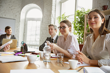 Image showing Group of young business professionals having a meeting, creative office