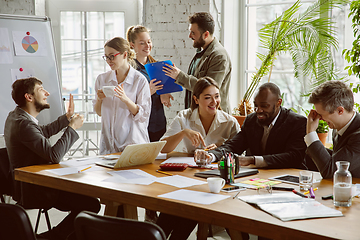 Image showing Group of young business professionals having a meeting, creative office