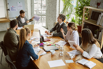 Image showing Group of young business professionals having a meeting, creative office