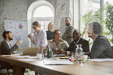 Image showing Group of young business professionals having a meeting, creative office