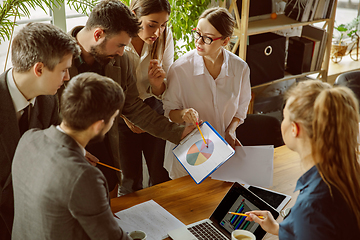 Image showing Group of young business professionals having a meeting, creative office