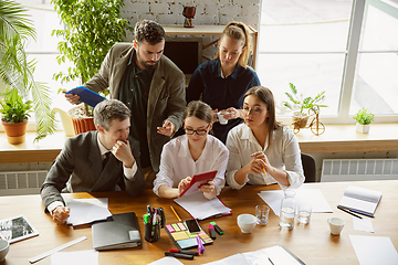 Image showing Group of young business professionals having a meeting, creative office