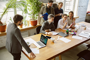 Image showing Group of young business professionals having a meeting, creative office