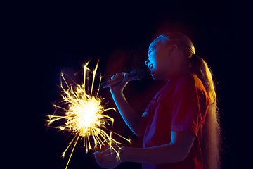 Image showing Caucasian girl\'s portrait isolated on dark studio background in neon light