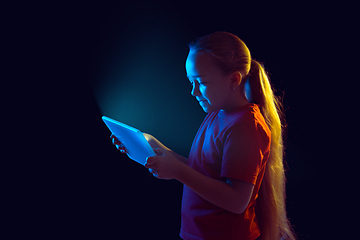 Image showing Caucasian girl\'s portrait isolated on dark studio background in neon light