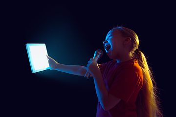 Image showing Caucasian girl\'s portrait isolated on dark studio background in neon light