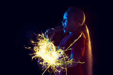 Image showing Caucasian girl\'s portrait isolated on dark studio background in neon light