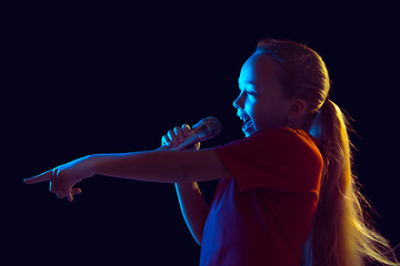 Image showing Caucasian girl\'s portrait isolated on dark studio background in neon light