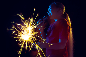 Image showing Caucasian girl\'s portrait isolated on dark studio background in neon light