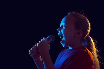 Image showing Caucasian girl\'s portrait isolated on dark studio background in neon light