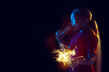 Image showing Caucasian girl\'s portrait isolated on dark studio background in neon light