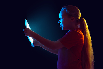 Image showing Caucasian girl\'s portrait isolated on dark studio background in neon light