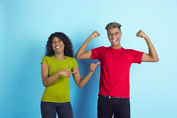 Image showing Young emotional african-american man and woman on blue background