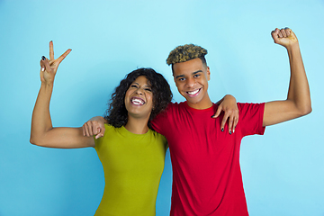 Image showing Young emotional african-american man and woman on blue background