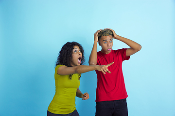 Image showing Young emotional african-american man and woman on blue background