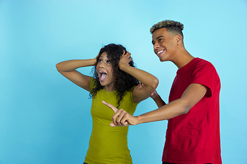 Image showing Young emotional african-american man and woman on blue background