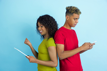 Image showing Young emotional african-american man and woman on blue background