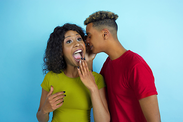 Image showing Young emotional african-american man and woman on blue background