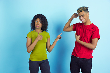 Image showing Young emotional african-american man and woman on blue background