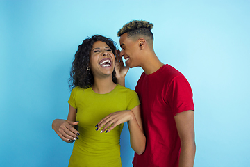 Image showing Young emotional african-american man and woman on blue background