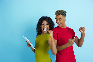 Image showing Young emotional african-american man and woman on blue background