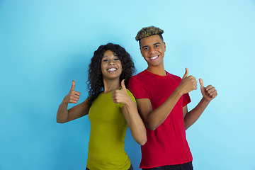 Image showing Young emotional african-american man and woman on blue background