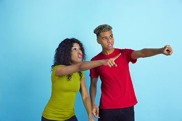 Image showing Young emotional african-american man and woman on blue background