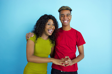 Image showing Young emotional african-american man and woman on blue background