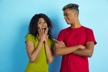 Image showing Young emotional african-american man and woman on blue background