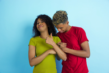 Image showing Young emotional african-american man and woman on blue background