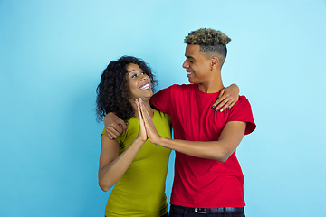 Image showing Young emotional african-american man and woman on blue background