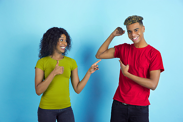 Image showing Young emotional african-american man and woman on blue background