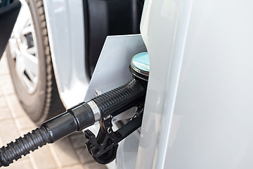 Image showing White clean car refueling on a petrol station