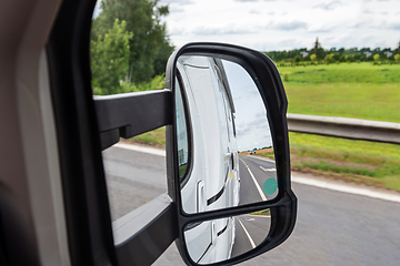 Image showing Road view from the side mirror. Traveling by car