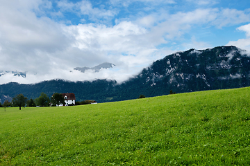 Image showing Beautiful green mountains landscape in Switzerland Alps. Small house