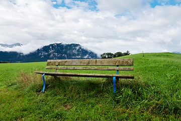 Image showing A calm place to rest and relax. An empty wooden bench. Switzerland