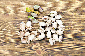 Image showing pistachios on wood background