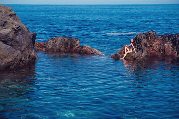 Image showing beautiful girl resting in natural ocean swimming pool