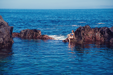 Image showing beautiful girl resting in natural ocean swimming pool