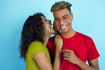 Image showing Young emotional african-american man and woman on blue background