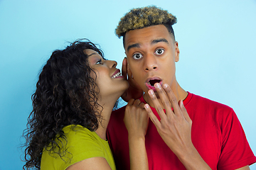 Image showing Young emotional african-american man and woman on blue background