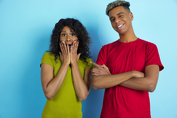 Image showing Young emotional african-american man and woman on blue background