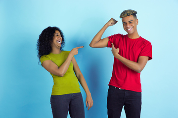 Image showing Young emotional african-american man and woman on blue background