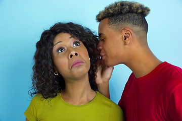 Image showing Young emotional african-american man and woman on blue background