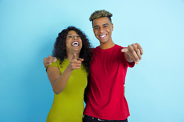 Image showing Young emotional african-american man and woman on blue background