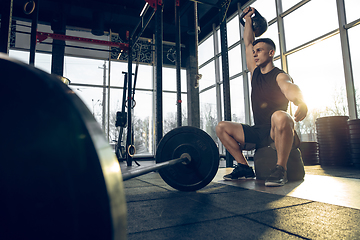 Image showing The male athlete training hard in the gym. Fitness and healthy life concept.