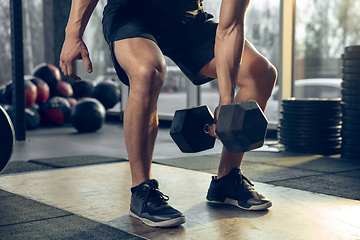 Image showing The male athlete training hard in the gym. Fitness and healthy life concept.