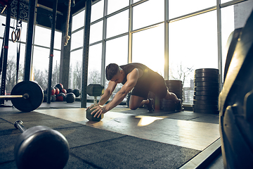 Image showing The male athlete training hard in the gym. Fitness and healthy life concept.