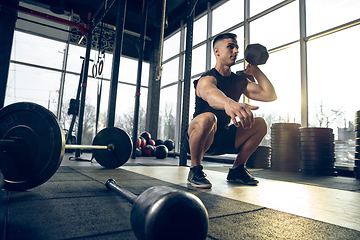 Image showing The male athlete training hard in the gym. Fitness and healthy life concept.