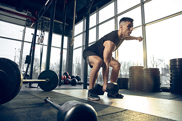 Image showing The male athlete training hard in the gym. Fitness and healthy life concept.